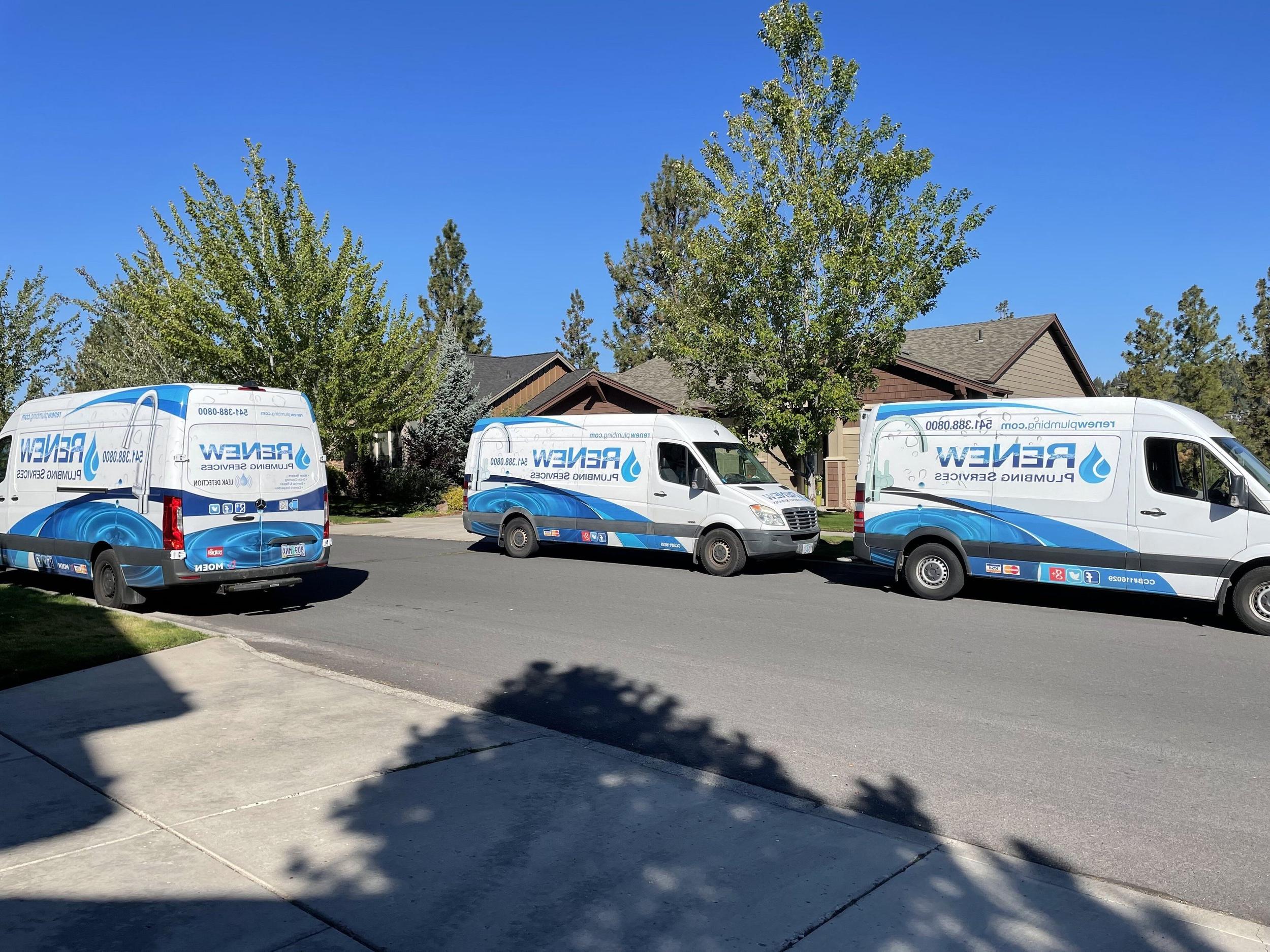 Three Renew Plumbing service vans parked together in Bend, Oregon.