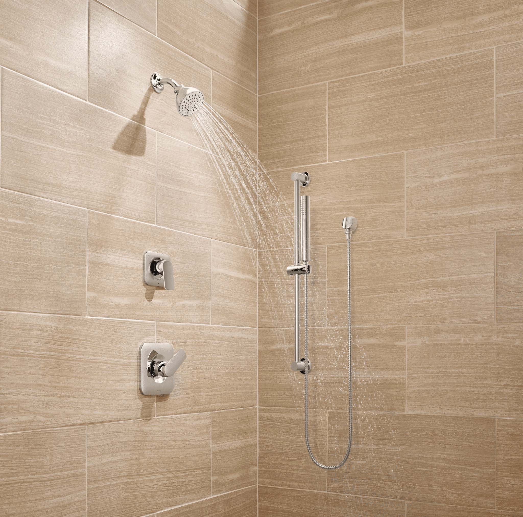 Beige tiled shower with updated shower fixtures. shower head turned on.