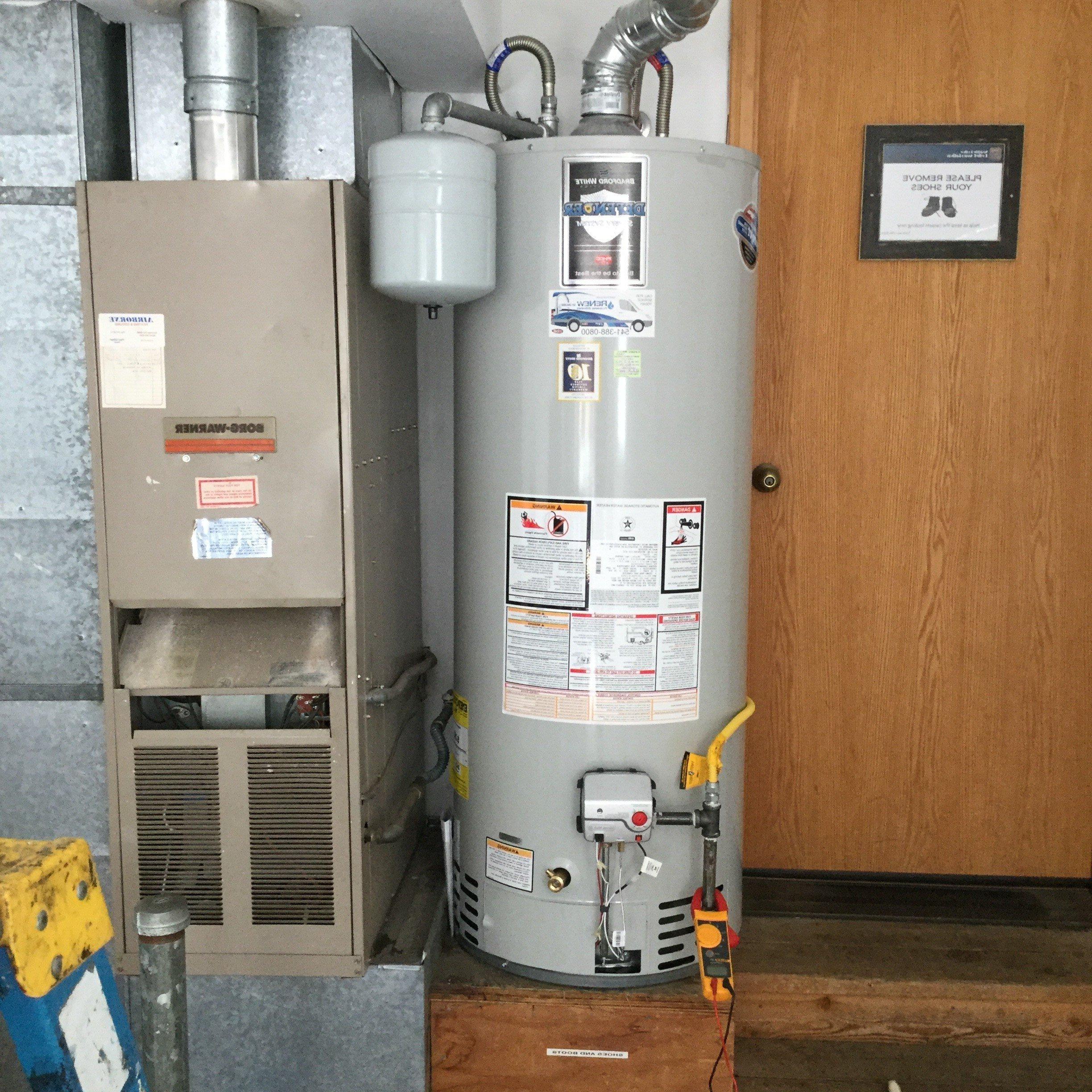 Water heater tank installed in a garage.